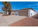 Well-maintained single-story home featuring a neutral color palette and low-maintenance landscaping at 8567 N 107Th Dr, Peoria, AZ 85345