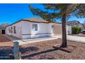 Inviting single-level home with a tidy front yard, xeriscaping, and an attached garage at 8567 N 107Th Dr, Peoria, AZ 85345