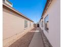 Property featuring low-maintenance desert landscaping and block wall fencing for added privacy at 8567 N 107Th Dr, Peoria, AZ 85345