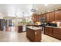 Spacious kitchen with stainless steel appliances, granite countertops, and dark wood cabinets at 860 E Cierra Cir, San Tan Valley, AZ 85143