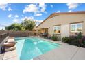 Refreshing backyard pool with a fence for safety and mature landscaping at 860 E Cierra Cir, San Tan Valley, AZ 85143