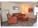 Bright living room features leather seating, a colorful rug, and accent lighting at 8649 E Royal Palm Rd # 213, Scottsdale, AZ 85258