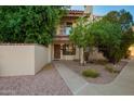 Cozy condo with a private balcony, mature trees, and easy access via the well-maintained walkway at 1017 E Maryland Ave # 110, Phoenix, AZ 85014