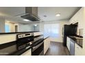 Updated kitchen with stainless steel appliances, white cabinets and plenty of counter space at 10562 W Campana Dr, Sun City, AZ 85351