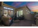 Cozy patio with cushioned chairs, a table, and a built-in grill under the twilight at 1488 E Sweet Citrus Dr, Queen Creek, AZ 85140