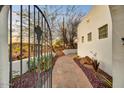 Front walkway featuring a stone pathway, desert landscaping and a custom gate at 16410 E Leo Dr, Fountain Hills, AZ 85268