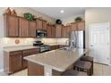 Well-equipped kitchen with granite countertops, stainless steel appliances, and a breakfast bar at 17642 W Verdin Rd, Goodyear, AZ 85338