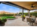 Expansive covered patio with elegant seating area, stunning mountain views and manicured lawn, ideal for outdoor living at 17991 N 95Th St, Scottsdale, AZ 85255