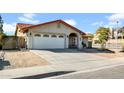 Side view of a well-kept home with desert landscaping and a two-car garage at 1801 E Hearn Rd, Phoenix, AZ 85022