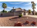 Rear view of a single-story home with desert landscaping and a fenced yard at 21041 N 61St Dr, Glendale, AZ 85308