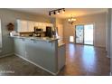 Bright kitchen with stainless steel appliances, tiled floors, and a breakfast bar at 236 N Wesley --, Mesa, AZ 85207