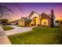 Brick home showing arched entrance, manicured lawn, and circular driveway at 2458 E Melrose St, Mesa, AZ 85213