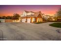 Three-car garage with a spacious driveway and beautifully landscaped grounds at 2458 E Melrose St, Mesa, AZ 85213