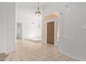 Bright foyer boasts tile floors, a wooden front door, high ceilings and modern light fixtures at 27467 N 75Th Way, Scottsdale, AZ 85266
