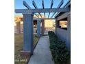 Covered walkway features modern supports, mature shrubs, and access to the front entrance at 276 Leisure World --, Mesa, AZ 85206