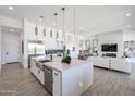 Bright, open-concept kitchen featuring a large island, stainless steel appliances, and views into the living area at 28265 N 158Th St, Scottsdale, AZ 85262