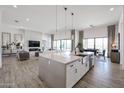 Open floor plan boasts a kitchen island, sleek pendant lighting, and seamless flow to the dining and living spaces at 28265 N 158Th St, Scottsdale, AZ 85262