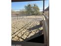 Well-maintained horse stall featuring secure fencing and a comfortable sand base, ensuring a safe and relaxing environment at 35515 N 215Th Dr, Wittmann, AZ 85361