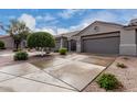 Charming single-story home showcasing a low maintenance desert landscape and an attached two-car garage at 4202 E Broadway Rd # 93, Mesa, AZ 85206