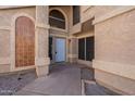 Inviting front entrance with a light blue door, decorative windows, and elegant architectural details at 433 E Utopia Rd, Phoenix, AZ 85024