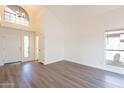 Open living area with vaulted ceiling, hardwood floors, large windows, and a modern chandelier at 433 E Utopia Rd, Phoenix, AZ 85024
