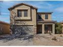 Charming two-story home featuring a well-maintained yard, two-car garage and welcoming front porch at 44196 W Askew Dr, Maricopa, AZ 85138