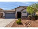 Beautiful single-story home featuring desert landscaping, a two-car garage, and stone accents at 4960 S Wade Dr, Gilbert, AZ 85298