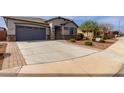 Well-maintained single-story home with desert landscaping, a two-car garage, and a spacious driveway at 4960 S Wade Dr, Gilbert, AZ 85298
