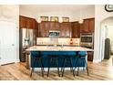 Modern kitchen featuring stainless steel appliances, granite countertops, and a center island with seating at 808 E Constance Way, Phoenix, AZ 85042