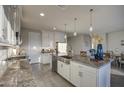 Modern kitchen boasts stainless steel appliances, a spacious island, and ample white cabinetry with granite countertops at 8420 S 69Th Ln, Laveen, AZ 85339