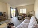 Cozy living room filled with natural light, a comfortable sofa, and stylish decor at 10330 W Thunderbird Blvd # C128, Sun City, AZ 85351