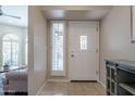 Bright entryway featuring tile flooring, a side window, and a white door with decorative glass panel at 10490 E Dreyfus E Ave, Scottsdale, AZ 85260