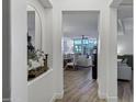 Inviting hallway view through an arched doorway, showcasing a dining and living area with wood floors at 120 E Rio Salado Pkwy # 101, Tempe, AZ 85281