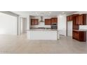 Open-concept kitchen boasts a large island with granite countertops and stainless steel appliances at 13803 W Calle De Baca --, Peoria, AZ 85383