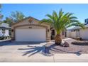 Single-story home featuring low maintenance desert landscaping and a two car garage at 18051 N 88Th Dr, Peoria, AZ 85382