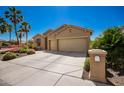Inviting home with desert landscaping, three-car garage and a well-manicured front yard at 1822 N 164Th Dr # 58, Goodyear, AZ 85395
