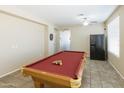Spacious game room featuring a well-maintained pool table, neutral paint, and tile floors at 18342 W La Mirada Dr, Goodyear, AZ 85338