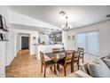 Open-concept dining area with chandelier and tile flooring adjacent to the kitchen at 18648 W Lupine Ave, Goodyear, AZ 85338