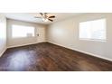 Bright living room featuring hard wood floors, neutral walls, a ceiling fan, and lots of natural light at 2027 W Monte Vista Rd, Phoenix, AZ 85009