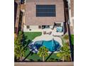 Aerial view of backyard featuring pool, spa, patio area, solar panels, and low-maintenance landscaping at 21857 N Gibson Dr, Maricopa, AZ 85139