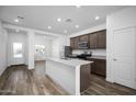 Modern kitchen features stainless steel appliances, granite countertops, and a central island at 24577 W St Anne Ave, Buckeye, AZ 85326