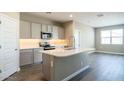 Open kitchen featuring gray cabinets, stainless steel appliances, and a quartz-topped island at 2480 S 241St Ave, Buckeye, AZ 85326