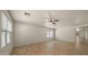 Bright living room with ceiling fan and tile floors at 2725 W Silver Creek Ln, San Tan Valley, AZ 85144