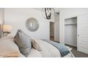 Chic bedroom featuring a modern hanging light fixture and a sliding door closet at 28200 N Nealite Dr, San Tan Valley, AZ 85143