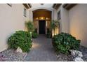 Inviting front entrance featuring manicured landscaping and a charming brick walkway at 41711 N Pinion Hills Ct, Anthem, AZ 85086