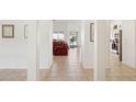 Bright hallway leading to the living area and kitchen with views of the outdoor patio at 4936 E Villa Rita Dr, Scottsdale, AZ 85254