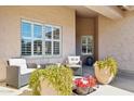 Inviting outdoor seating area with comfortable furniture and lush potted plants, perfect for relaxation at 4936 E Villa Rita Dr, Scottsdale, AZ 85254