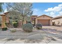 Beautiful single-story home featuring stone accents, a three-car garage, and desert landscaping at 5334 S Parkwood --, Mesa, AZ 85212