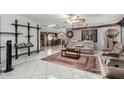 Bright living room with tile floors, decorative shelving, and a large rug at 6217 W Orange Dr, Glendale, AZ 85301