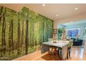 Dining room with a green leaf forest mural wall, with hardwood floors and recessed lighting at 9441 W Long Hills Dr, Sun City, AZ 85351